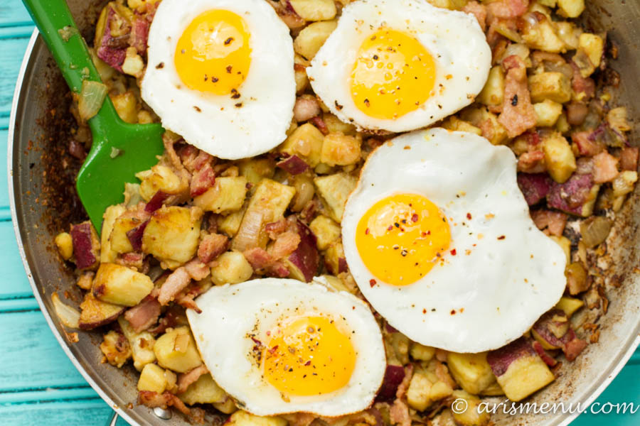 Paleo Sweet Potato Breakfast Hash: Warm, hearty and comforting breakfast hash with sweet potato, onions, center cut bacon and fried eggs. So easy and crave-able!
