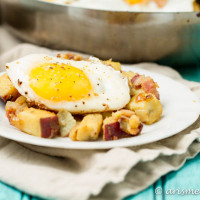 Paleo Sweet Potato Breakfast Hash: Warm, hearty and comforting breakfast hash with sweet potato, onions, center cut bacon and fried eggs. So easy and crave-able!